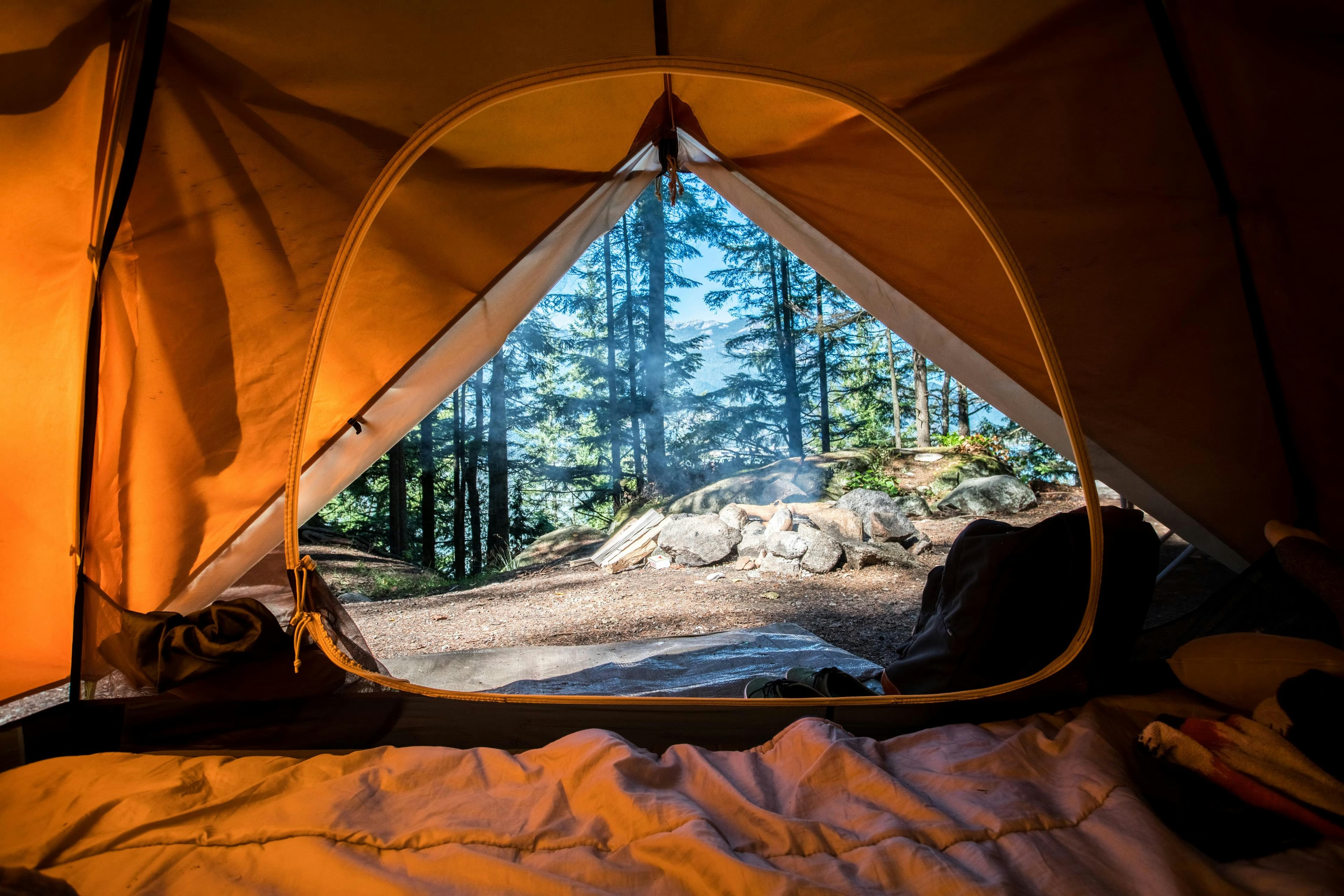 Scenic mountain campsite with a tent at sunset
